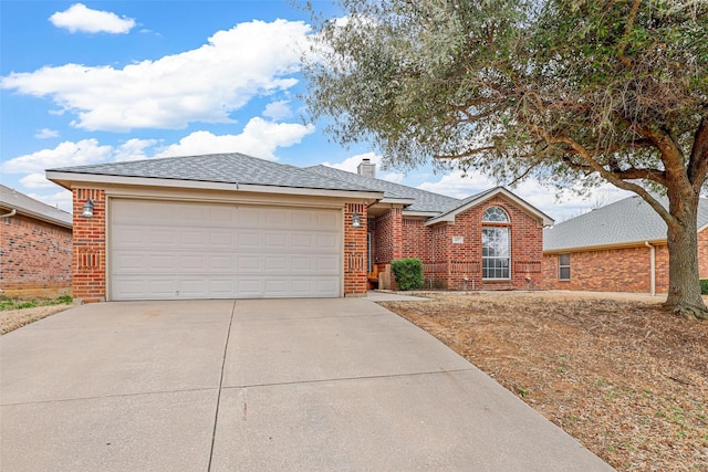 427 Nutmeg, Burleson, TX 76028 - view of front facade featuring brick siding, concrete driveway, an attached garage, and a chimney