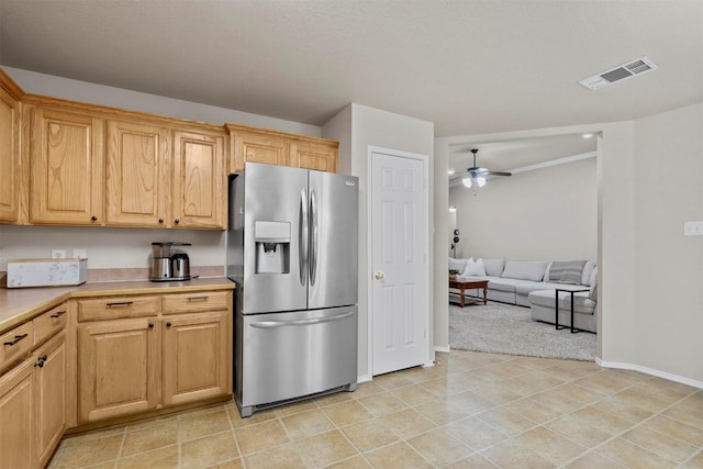 kitchen featuring stainless steel fridge, baseboards, visible vents, ceiling fan, and light countertops