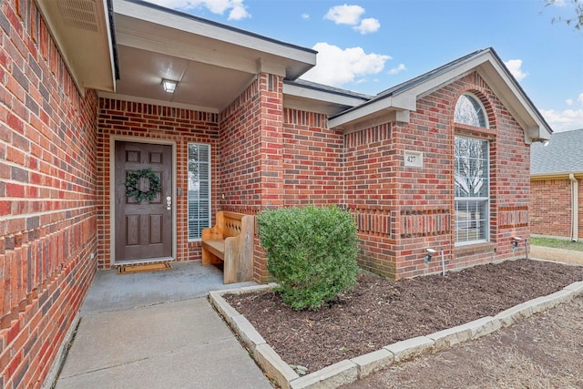 entrance to property with brick siding