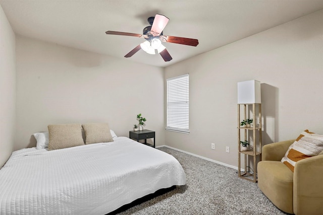 carpeted bedroom featuring baseboards and a ceiling fan