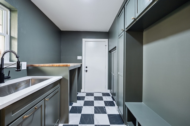 kitchen featuring dark floors, light countertops, and a sink