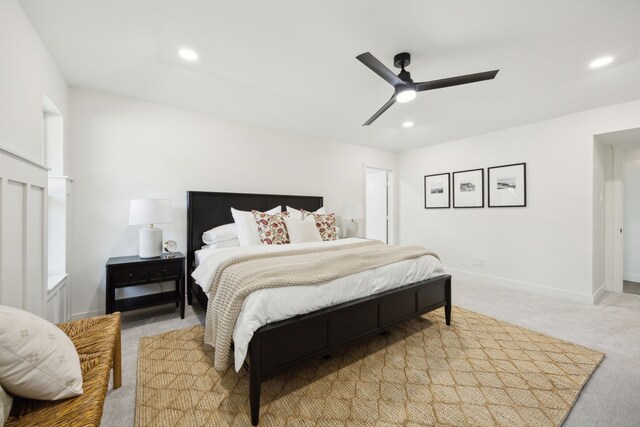 bedroom featuring light carpet, recessed lighting, and baseboards