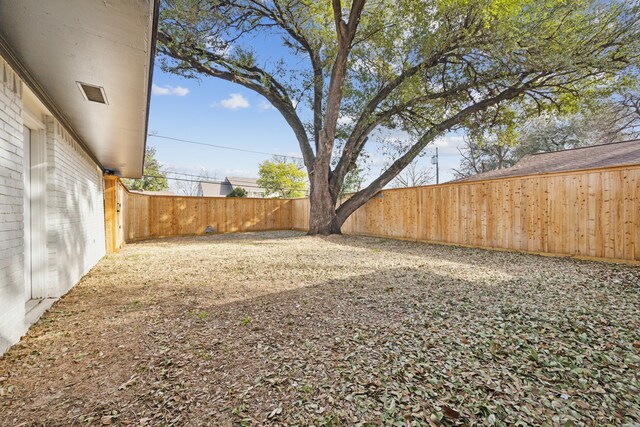 view of yard with a fenced backyard