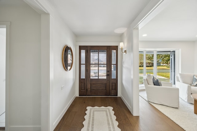 entrance foyer featuring baseboards and wood finished floors