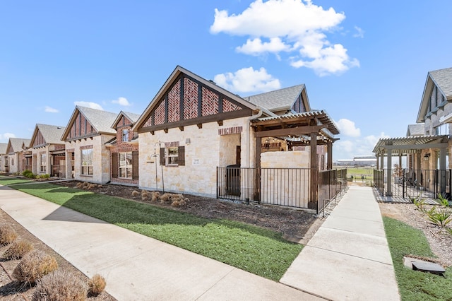 exterior space with a patio, stone siding, a residential view, fence, and a pergola