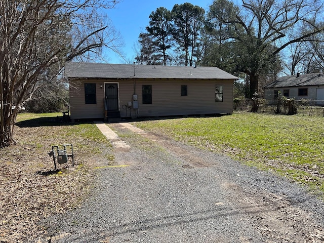 ranch-style home featuring a front yard and fence