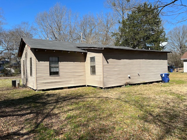 back of house with a lawn and cooling unit