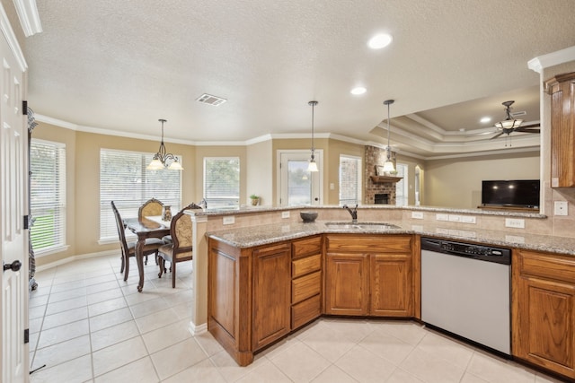 kitchen featuring dishwashing machine, crown molding, brown cabinetry, and a sink