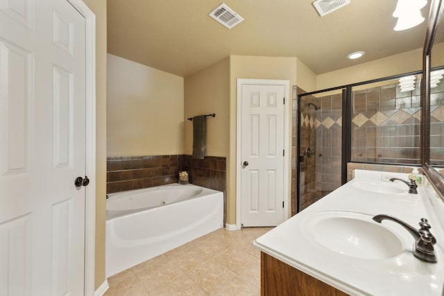 bathroom featuring tile patterned floors, visible vents, and a sink