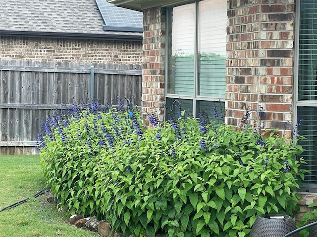 exterior details with brick siding and fence