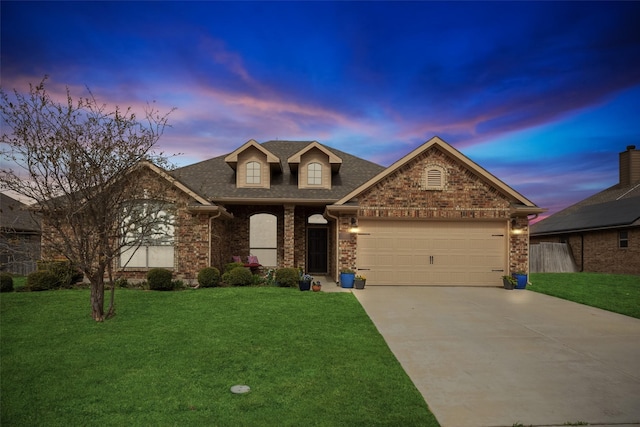 traditional-style house featuring brick siding, a front lawn, an attached garage, and driveway