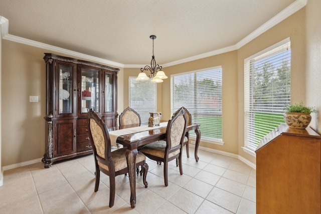 dining area featuring baseboards, an inviting chandelier, and crown molding