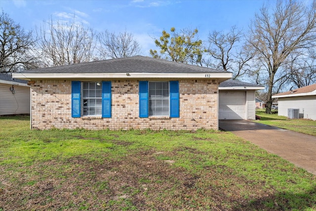 ranch-style home featuring driveway, brick siding, a front lawn, and central air condition unit