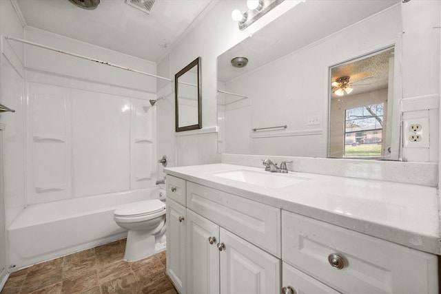 bathroom featuring toilet, visible vents, vanity, a ceiling fan, and  shower combination