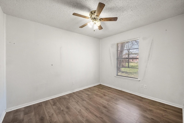 unfurnished room with a textured ceiling, wood finished floors, a ceiling fan, and baseboards