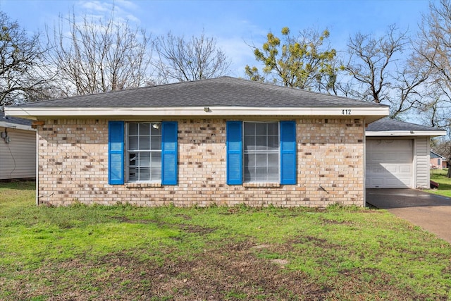 ranch-style house featuring a garage, brick siding, driveway, roof with shingles, and a front lawn