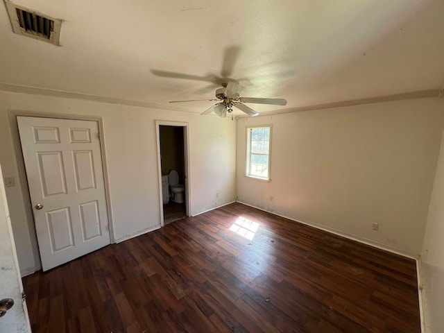 unfurnished bedroom with dark wood-type flooring, visible vents, and a ceiling fan