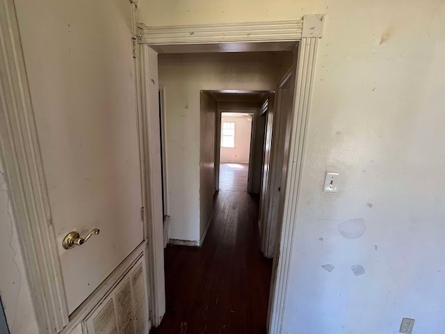 corridor featuring dark wood-style flooring and visible vents