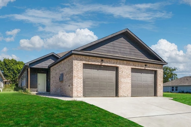 view of front of property featuring driveway, a garage, a front lawn, and brick siding