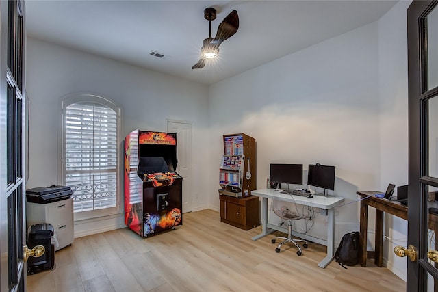 office space featuring wood finished floors, visible vents, and baseboards