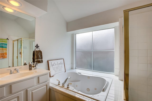 full bath with vaulted ceiling, vanity, a tub with jets, and a stall shower
