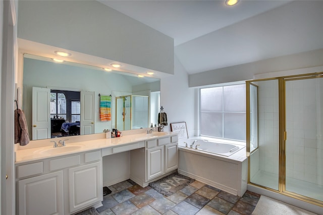 bathroom featuring a bath, a sink, vaulted ceiling, ensuite bathroom, and a shower stall