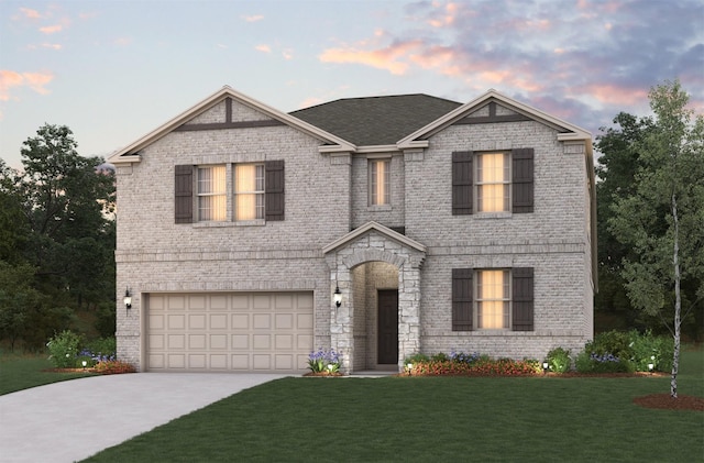 view of front of home featuring a garage, brick siding, a shingled roof, a yard, and driveway