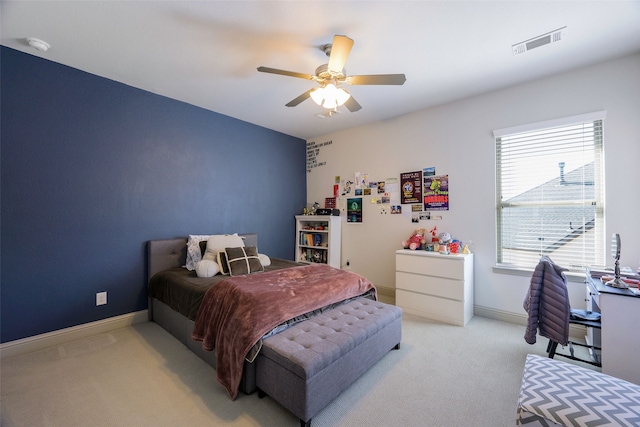 bedroom featuring a ceiling fan, light colored carpet, visible vents, and baseboards