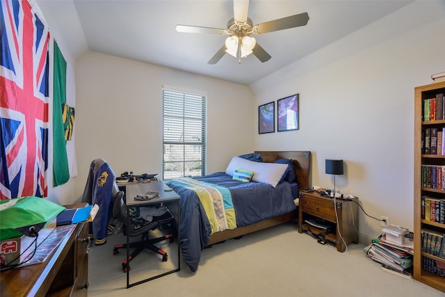 bedroom with ceiling fan, carpet flooring, and lofted ceiling