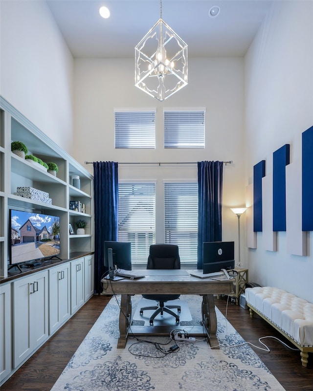 office area featuring a notable chandelier, a high ceiling, dark wood-style flooring, and recessed lighting