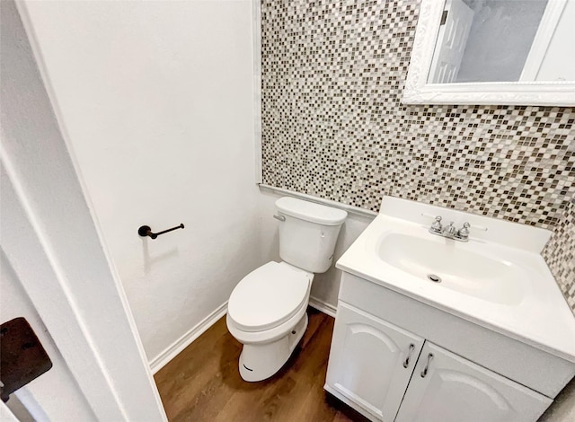 bathroom featuring wood finished floors, vanity, and toilet