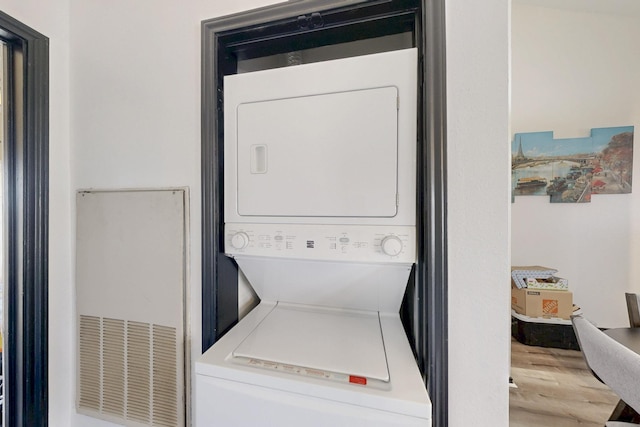 laundry room with laundry area and stacked washer and dryer