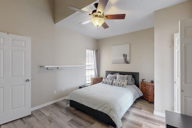 bedroom featuring light wood-style floors, baseboards, and ceiling fan