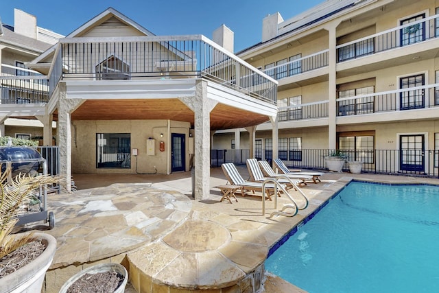 community pool with a patio area