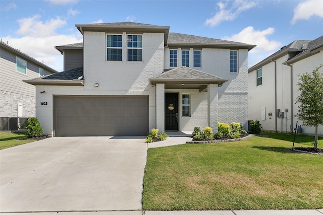 view of front of property with an attached garage, brick siding, concrete driveway, roof with shingles, and a front lawn