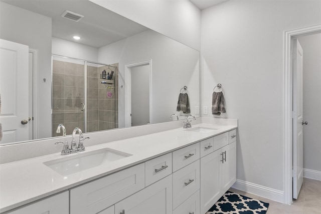 full bath with double vanity, a stall shower, a sink, and visible vents