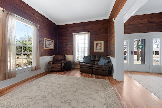 sitting room with wood finished floors and ornamental molding