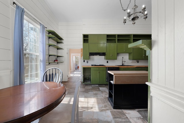 kitchen with range hood, green cabinetry, an inviting chandelier, open shelves, and a sink