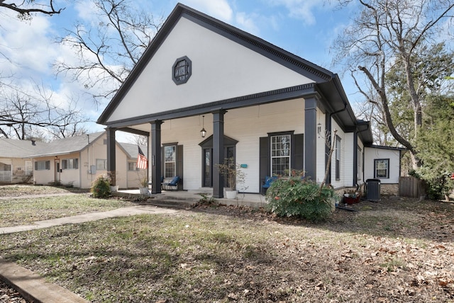 view of front of home with a porch and central AC