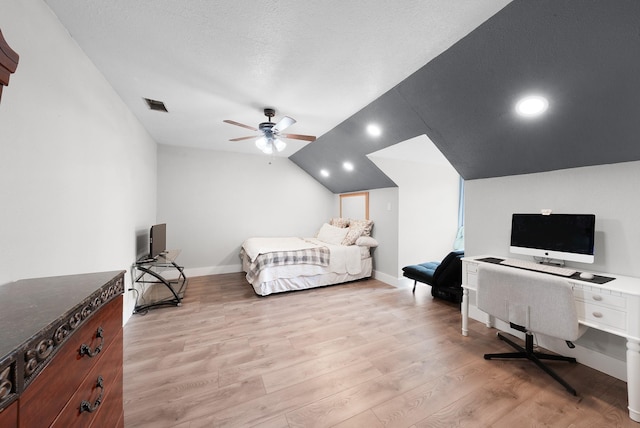 bedroom with visible vents, baseboards, light wood-style floors, and vaulted ceiling