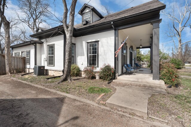 view of front of house with a porch and central AC