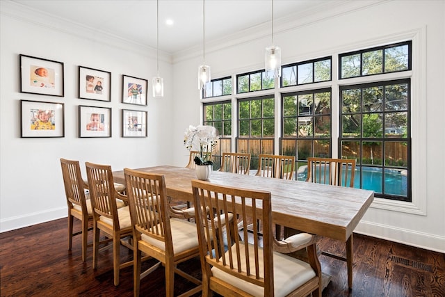 dining area featuring dark wood-style floors, baseboards, visible vents, and crown molding