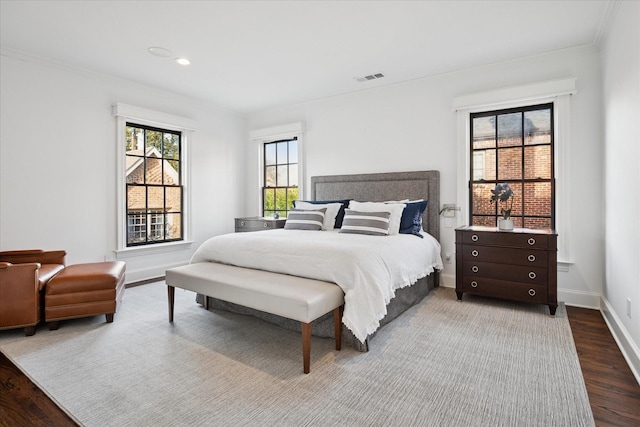 bedroom featuring visible vents, baseboards, wood finished floors, and recessed lighting