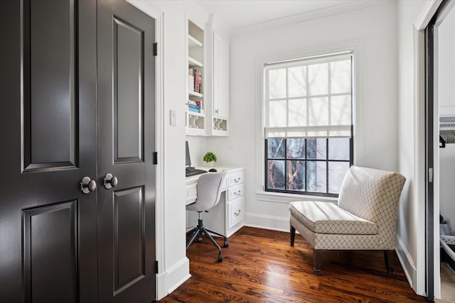 office featuring ornamental molding, built in study area, dark wood finished floors, and baseboards