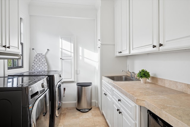 laundry room featuring cabinet space, baseboards, washer and clothes dryer, ornamental molding, and a sink