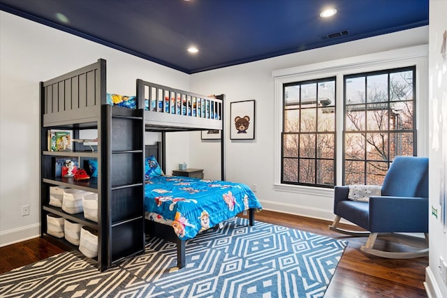 bedroom with baseboards, visible vents, wood finished floors, and recessed lighting