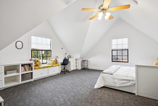 bedroom with a ceiling fan, vaulted ceiling, and dark carpet