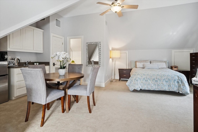 bedroom featuring lofted ceiling, baseboards, visible vents, and light colored carpet