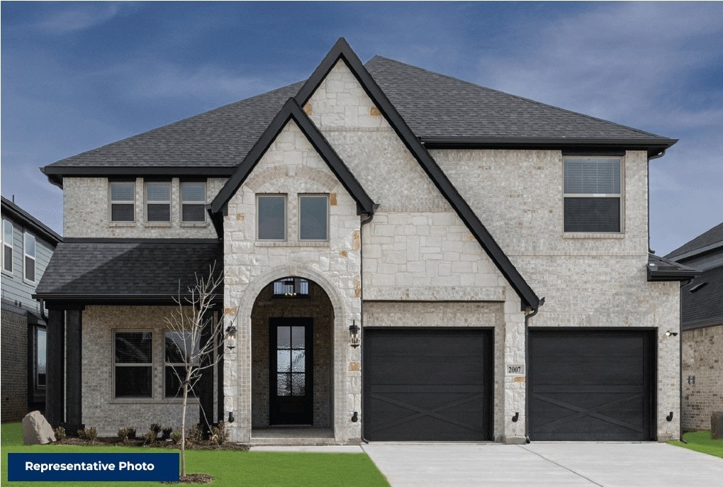 french country home featuring concrete driveway, stone siding, roof with shingles, an attached garage, and brick siding