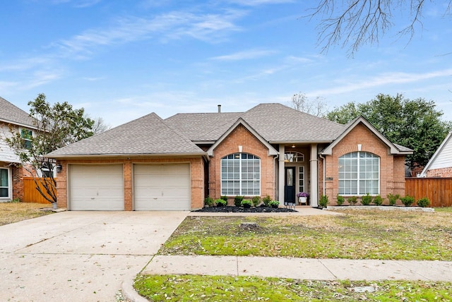 single story home with concrete driveway, a shingled roof, an attached garage, and fence